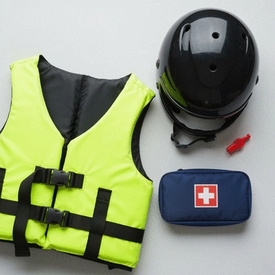 Close-up of various jet ski safety accessories like life jacket, helmet, whistle, and first aid kit laid out, no text, clean image